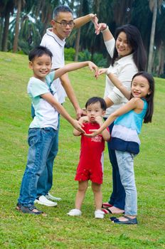 Outdoor portrait of asian family