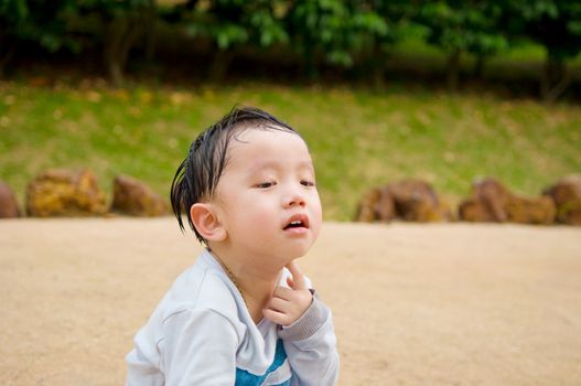Depressed Asian chinese child. Little boy crying at outdoor.