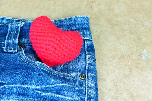 Crochet heart red color on blue Jeans