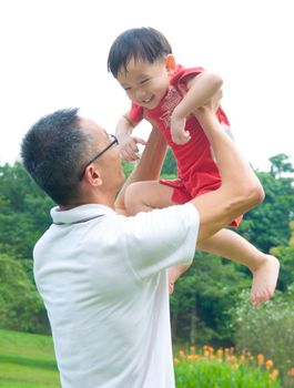 Asian father playing with baby boy