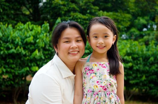 Outdoor portrait of asian mother and her lovely daughter