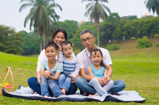 Outdoor portrait of asian family