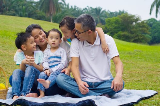 Outdoor portrait of asian family