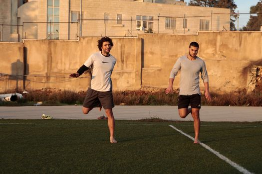 WEST BANK, Ramallah: Mohammed al-Khatib (L) trains at a track field at a high school in Ramallah, West Bank, on December 16, 2015. Mohammed al-Khatib is a 25 years-old yoga and fitness instructor living in Ramallah, who is training for a chance to race in the 100-meter and 200-meter track at the 2016 Olympic Games in Brazil. He recently raised through crowdfunding over $12,000 in a few days to go train in the U.S. where he will participate to races in order to qualify.