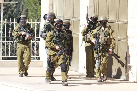 WEST BANK, Bethlehem: Members of Israeli security forces walk in the street during clashes with Palestinians in the West Bank town of Bethlehem following a funeral ceremony at the nearby Aida refugee camp on January 13, 2016. A Palestinian man identified as Srur Ahmad Abu Srur, 21, was buried at Aida refugee camp a day after he was allegedly shot in the chest by Israeli forces in Beit Jala, a Palestinian health ministry statement said. 