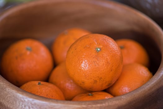 Ripe tangerines on wooden background