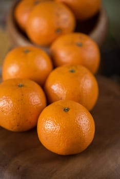 Ripe tangerines on wooden background
