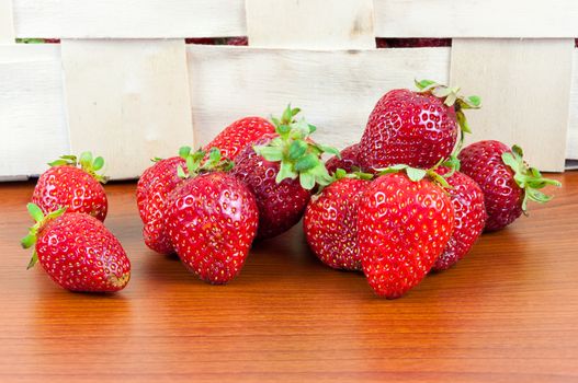 Closeup of fresh strawberries in front of a basket