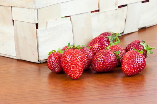 Closeup of fresh strawberries in front of a basket