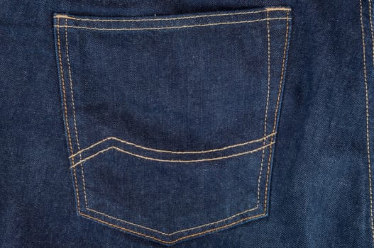 Empty pocket in dark blue jeans trousers
