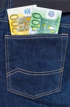 Euro banknotes in dark grey jeans pocket