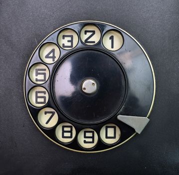 black vintage phone dial disk over plastic