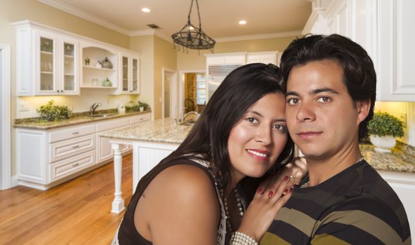 Affectionate Hispanic Couple Inside Custom Kitchen Interior.