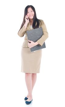 Business Women holding file standing while talking on mobile phone isolated over white background.