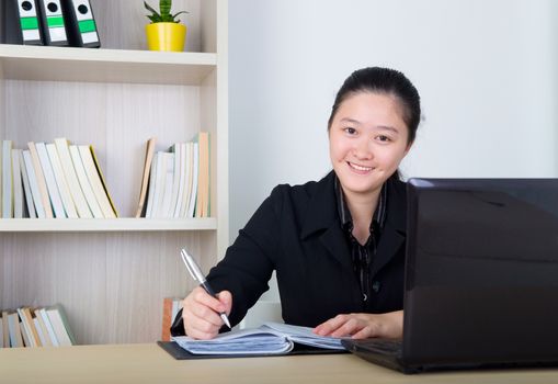 Beautiful asia young business woman with headset and laktop