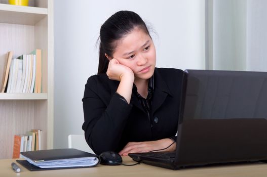 young business woman exhausted and bored in the office