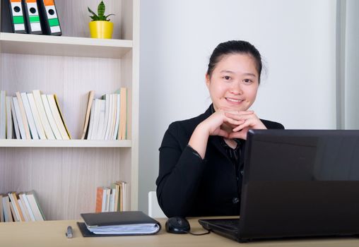 smiling young business woman working with laptop 
