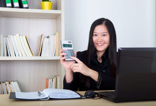 smart business woman showing the calculator in office