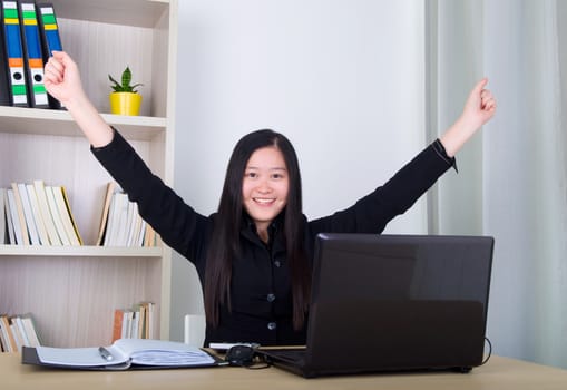 happy young asian business woman with success gesture 