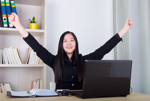 happy young asian business woman with success gesture