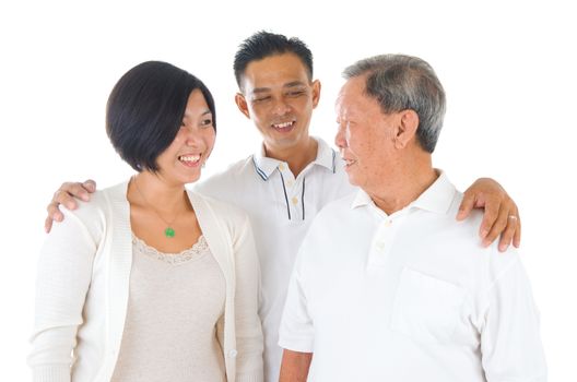 Senior man with his daughter and son. Happy Asian family senior father and adult offspring indoor portrait.