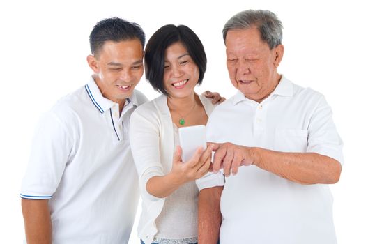 Modern technology, age and people concept. Asian senior man with his daughter and son taking selfie, using smartphone, self photographing. 