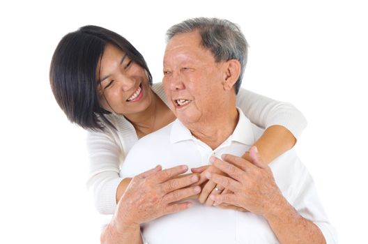 Senior man and daughter. Happy Asian family senior father and adult offspring having fun time at indoor studio.