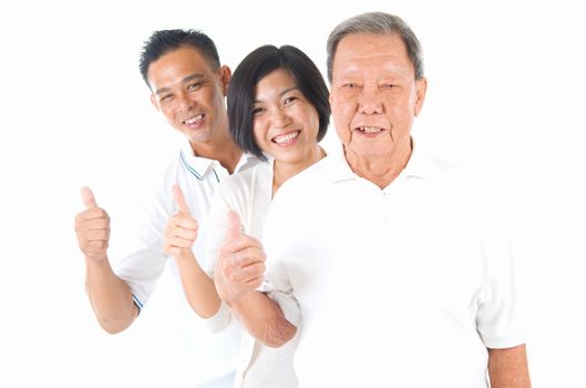 Senior man with his son and daughter. Happy Asian family senior father and adults offspring with thumb up gesture on isolated background.

