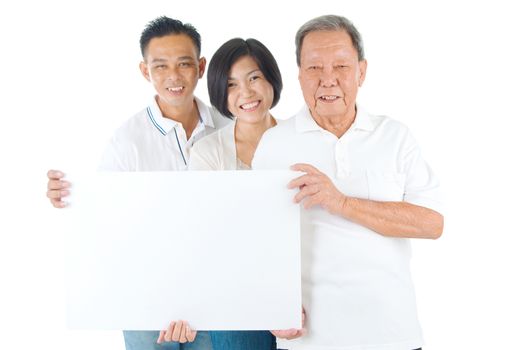 Senior man with his son and daughter. Happy Asian family senior father and adults offspring holding a blank white sign on isolated background.
