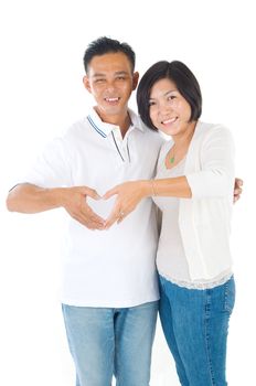 Happy middle aged Asian couple in love. Asian couple smiling isolated on white background.