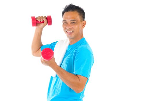 Portrait of fitness man working out with free weights in studio