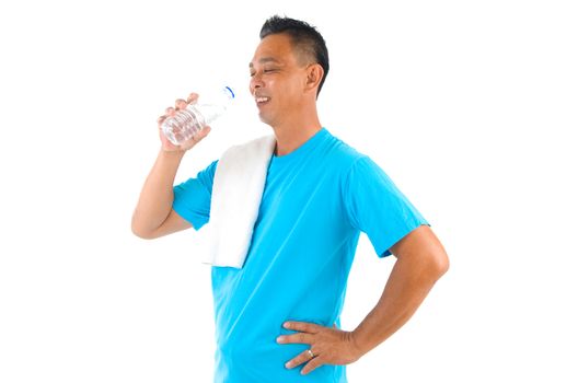 Sport man drinking water with towel after exercise.

