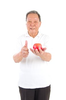 Closeup portrait senior man holding an apple, isolated on white background.