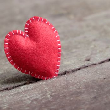 Red Valentine heart on wood background, one lonely heart in Valentine day, a special day for couple on feb 14, a abstract concept for love