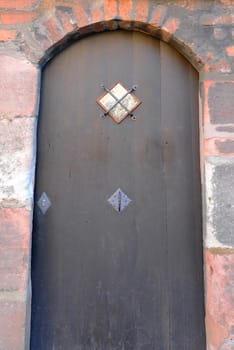 Ancient wooden door with stone frame