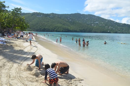 Children digging sand castles on the beach at Magens Bay,St.Thomas,U.S.Virgin Islands on 24 December 2015
