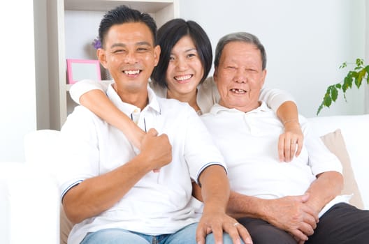 Asian senior father with his adult son and daughter at home. Family living lifestyle.