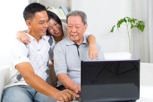 Asian senior man learns to use tablet computer