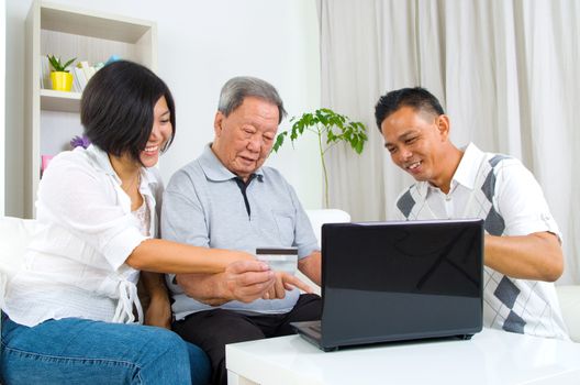 Asian senior man learns to use online internet banking
