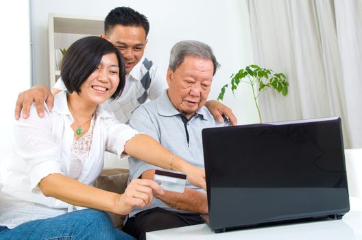 Asian senior man learns to use online internet banking