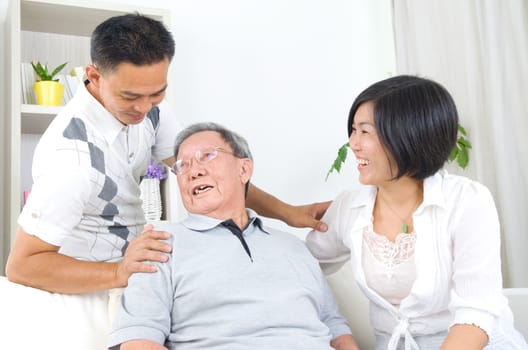 Asian senior father with his adult son and daughter at home. Family living lifestyle.