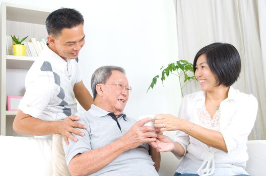 Asian senior father with his adult son and daughter at home. Family living lifestyle.