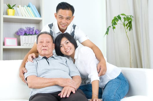 Asian senior father with his adult son and daughter at home. Family living lifestyle.