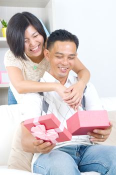 Asian girl surprises his boyfriend with a gift