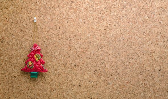 Cork message board with hanging red christmas tree