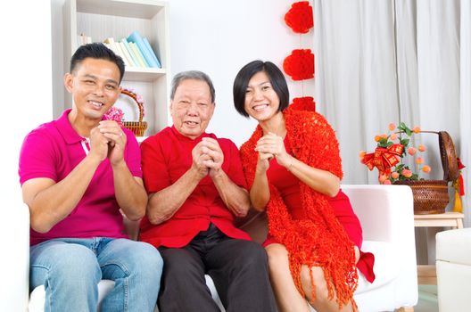 Asian senior man and children celebrating chinese new year