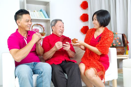 Asian senior man and children celebrating chinese new year