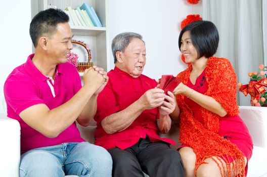 Asian senior man and children celebrating chinese new year