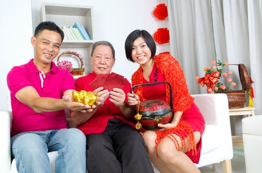 Asian senior man and children celebrating chinese new year