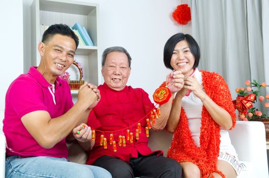 Asian senior man and children celebrating chinese new year